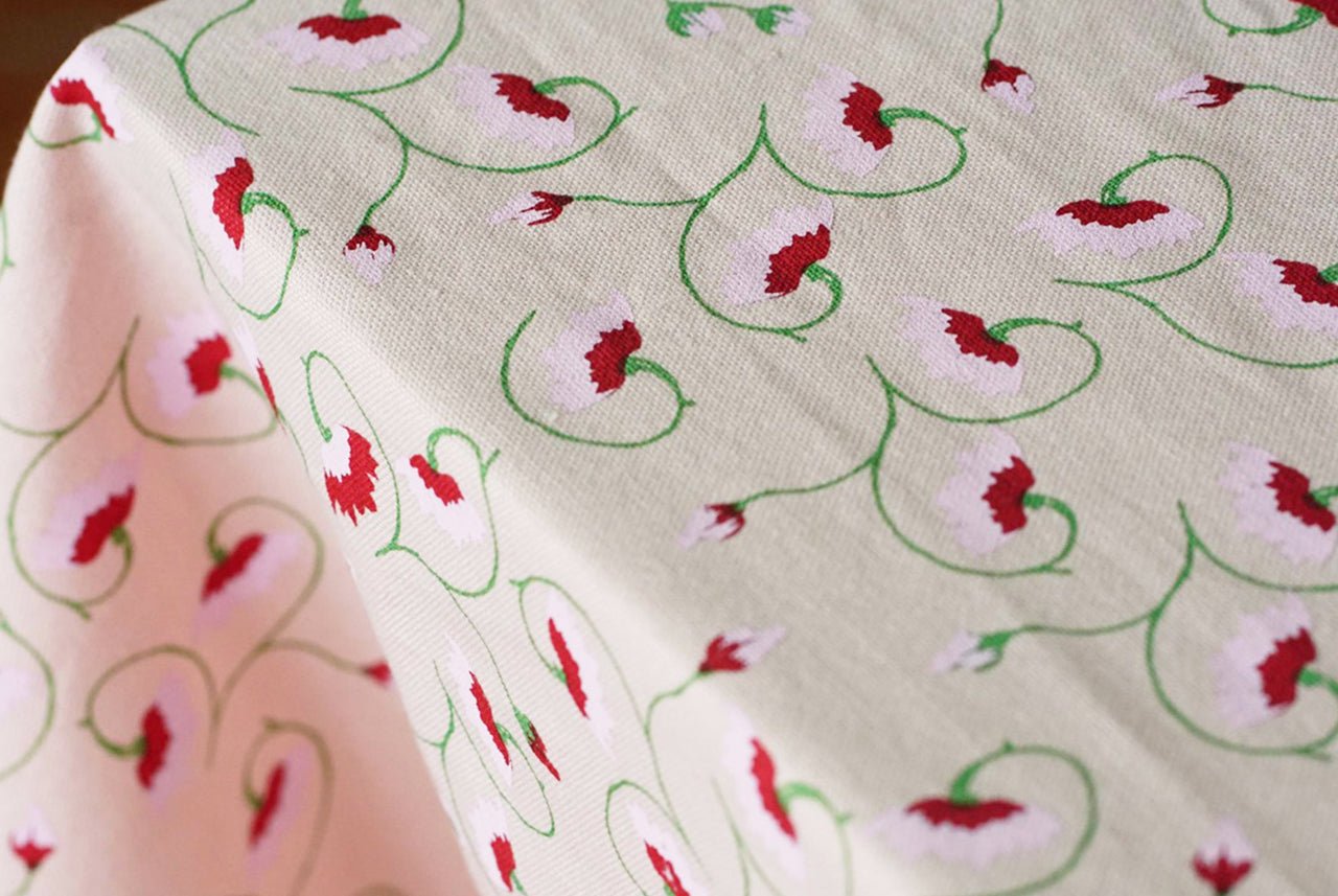 Light pink floral tablecloth styled on Italian-inspired tablescape