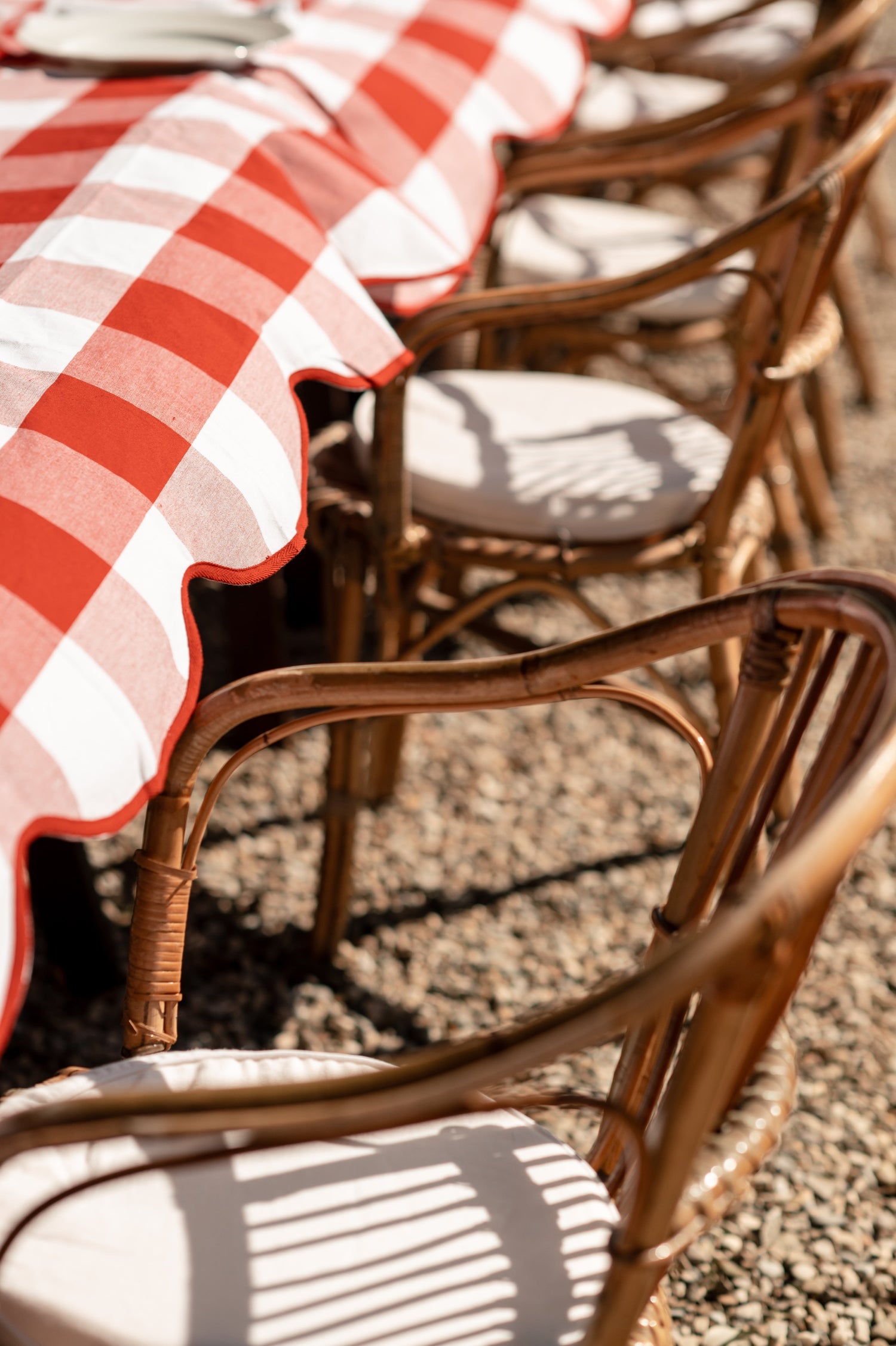 Scalloped red and white gingham table setting in the Tuscan Countryside