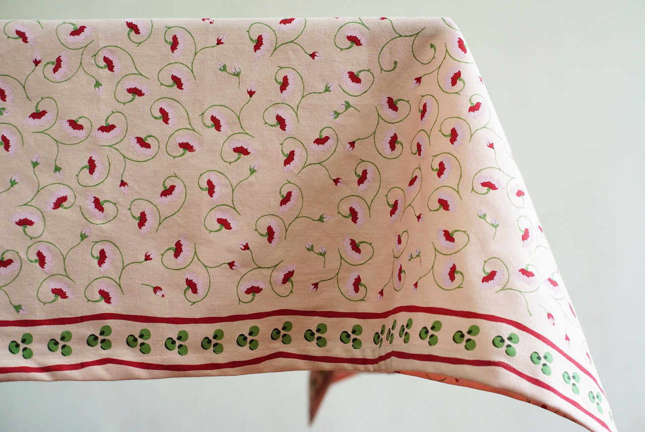 Light pink floral tablecloth inspired by Tuscan landscapes, hand screen printed in India. 