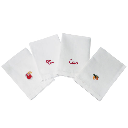 Set of four white napkins with embroidered designs on a white background