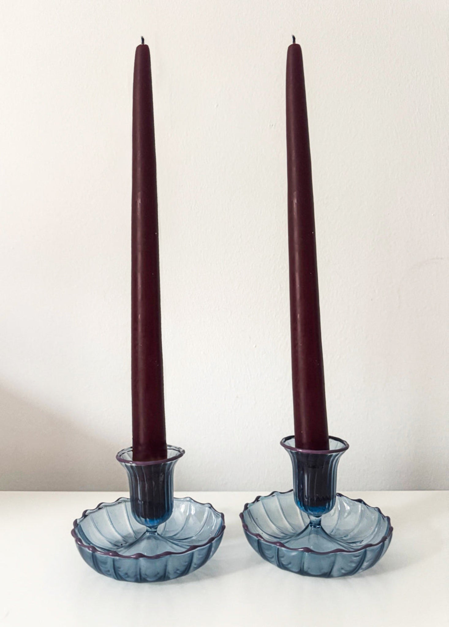 Pair of blue, fluted candle holders with contrast rim 