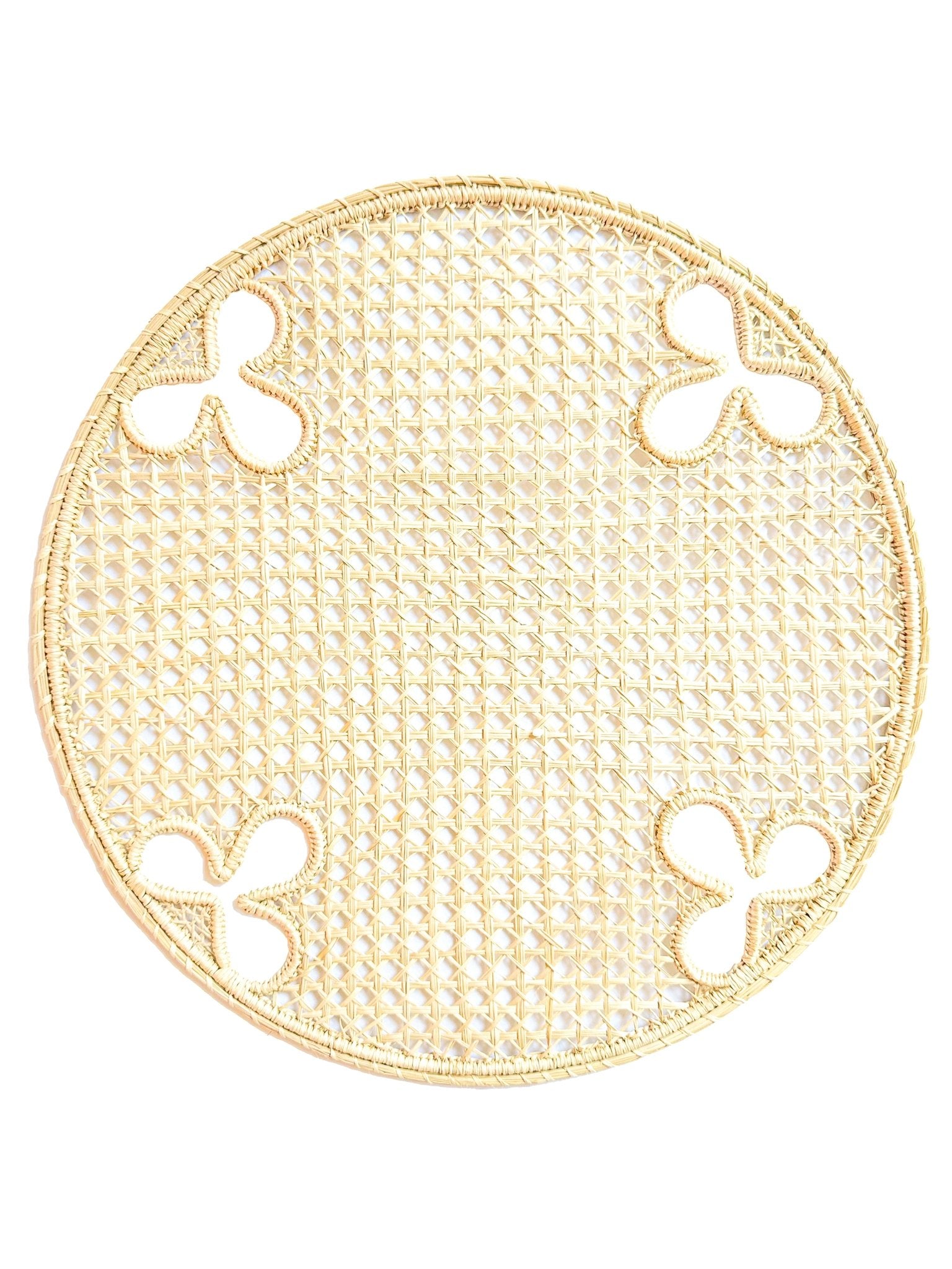 Handwoven iraca palm charger with olive branch motif. A Mediterranean-inspired foundation for elevated entertaining.