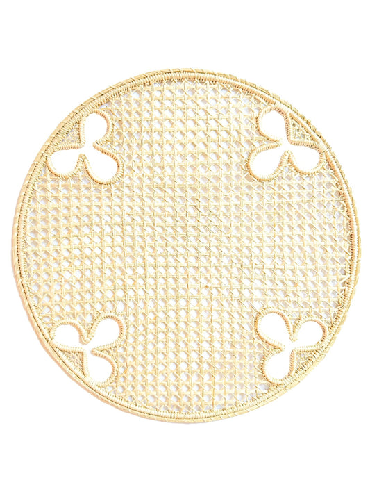 Handwoven iraca palm charger with olive branch motif. A Mediterranean-inspired foundation for elevated entertaining.